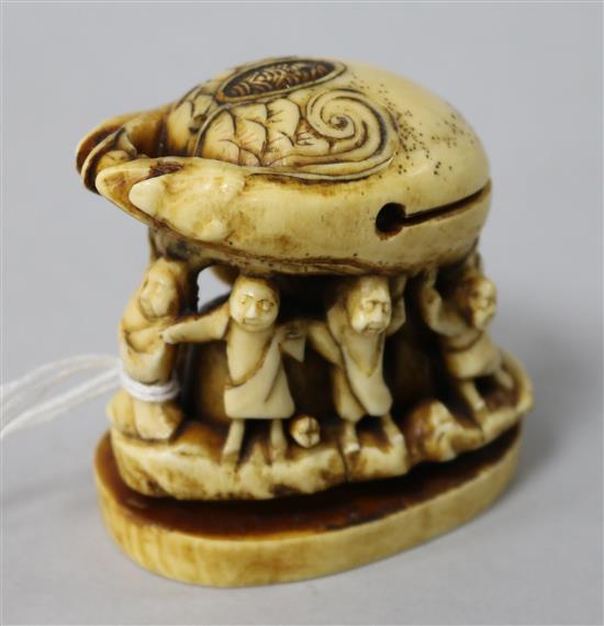 A resin group of figures under a crab
